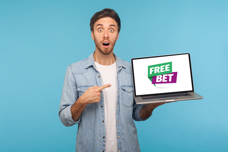 Man Holding Laptop With Free Bet Offer