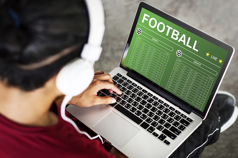Football betting on laptop