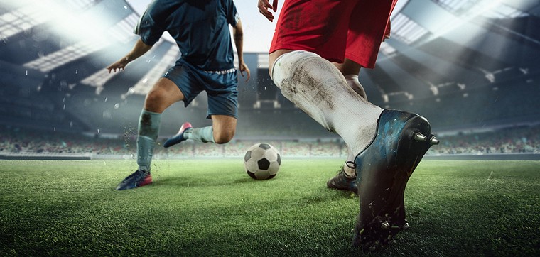 Footballers Wearing Red and Blue in Match