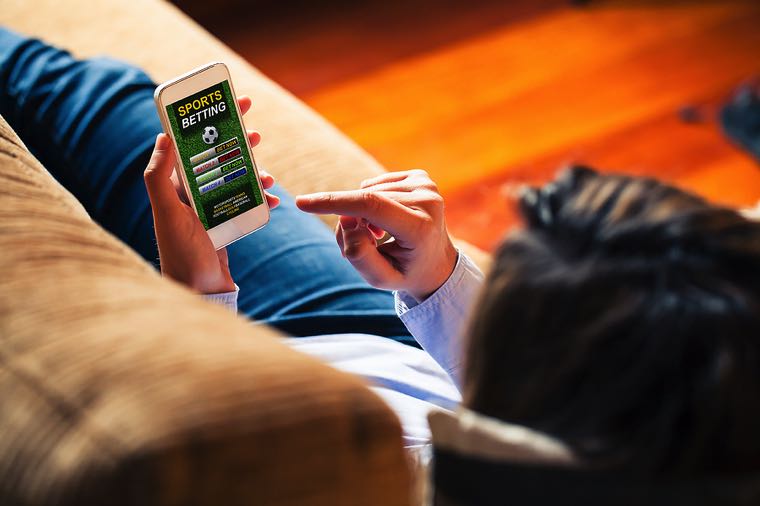 Woman placing football bet online
